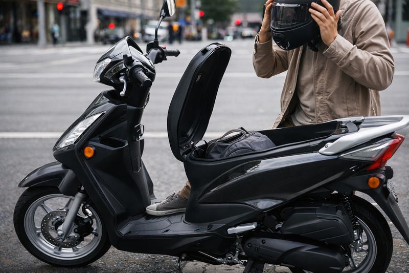 Scooter with step-through frame and under-seat storage, demonstrating comfort and practicality for city commuting.